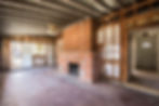 brick fireplace in gutted room