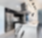Modern kitchen with black and white marble island, sleek stainless steel appliances, and black cabinetry. Bright lighting creates a stylish ambiance.